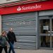 Closed Santander bank branch on a UK high street with shuttered doors and closure notice.